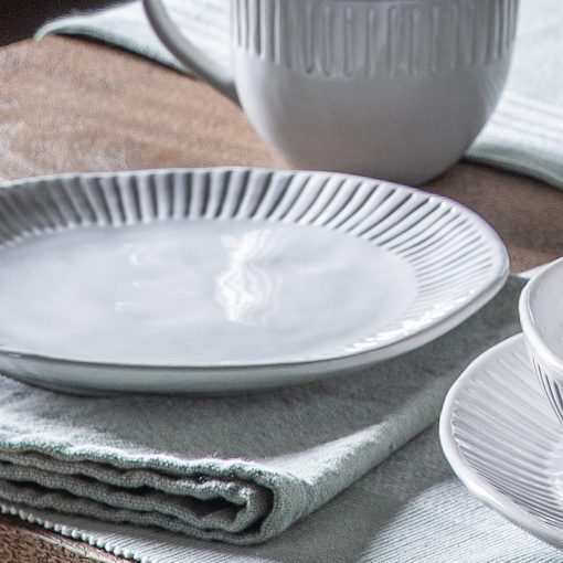 set of four vintage white porcelain side plates with an uneven rustic shape and ribbed edging