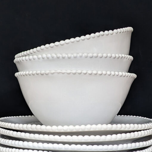 set of four white porcelain bowls with an uneven rustic shape and beaded edging