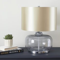 curved smoked glass table lamp base with a champagne silk effect drum lampshade