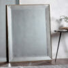 large rectangular bevelled glass wall mirror with a slim warm silver frame