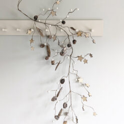 seasonal rustic garland with wooden stars, pine cones, faux white berries and pieces of bark attached to wired twigs