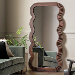 deep wooden framed full length mirror with a distinctive layered wavy edging and rich dark brown finish