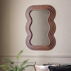 deep wooden framed wall mirror with a distinctive layered wavy edging and rich dark brown finish