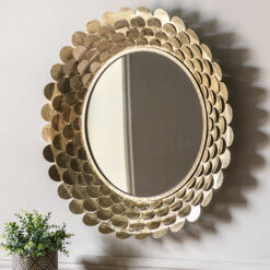 decorative round wall mirror with a deep metal frame made up of layers of cut out petals finished in a gold leaf