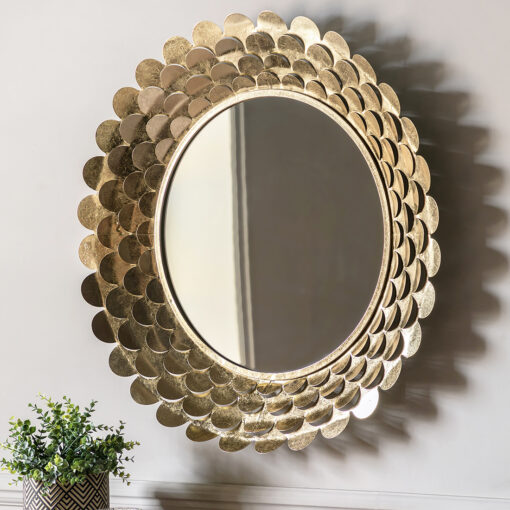 decorative round wall mirror with a deep metal frame made up of layers of cut out petals finished in a gold leaf