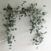 faux eucalyptus Christmas garland with subtle frosting and stems of delicate white berries