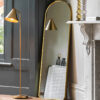 slim arched full-length wall mirror with a slim metal frame and warm gold finish