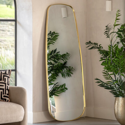 full length mirror with fluid curved edging and a slim metal frame finished in a warming gold