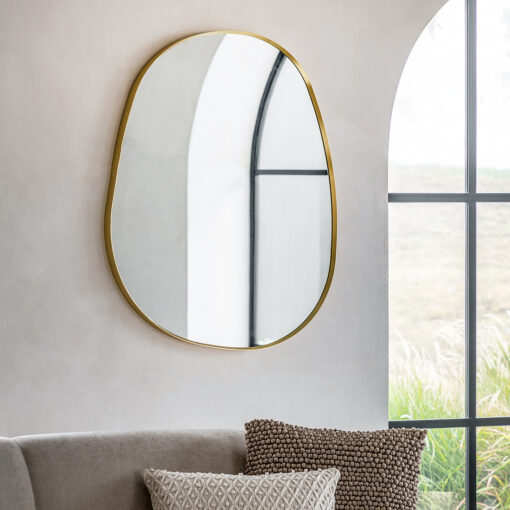 organic pebble-shaped wall mirror with a slim gold metal frame