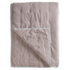 cotton blush pink bedspread with a white cross stitch design and flat pipe edging